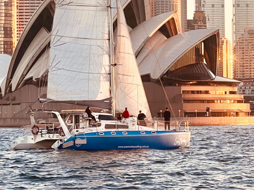 Sea Monkey Catamaran Sailing Past Opera House - private boat hire Sydney