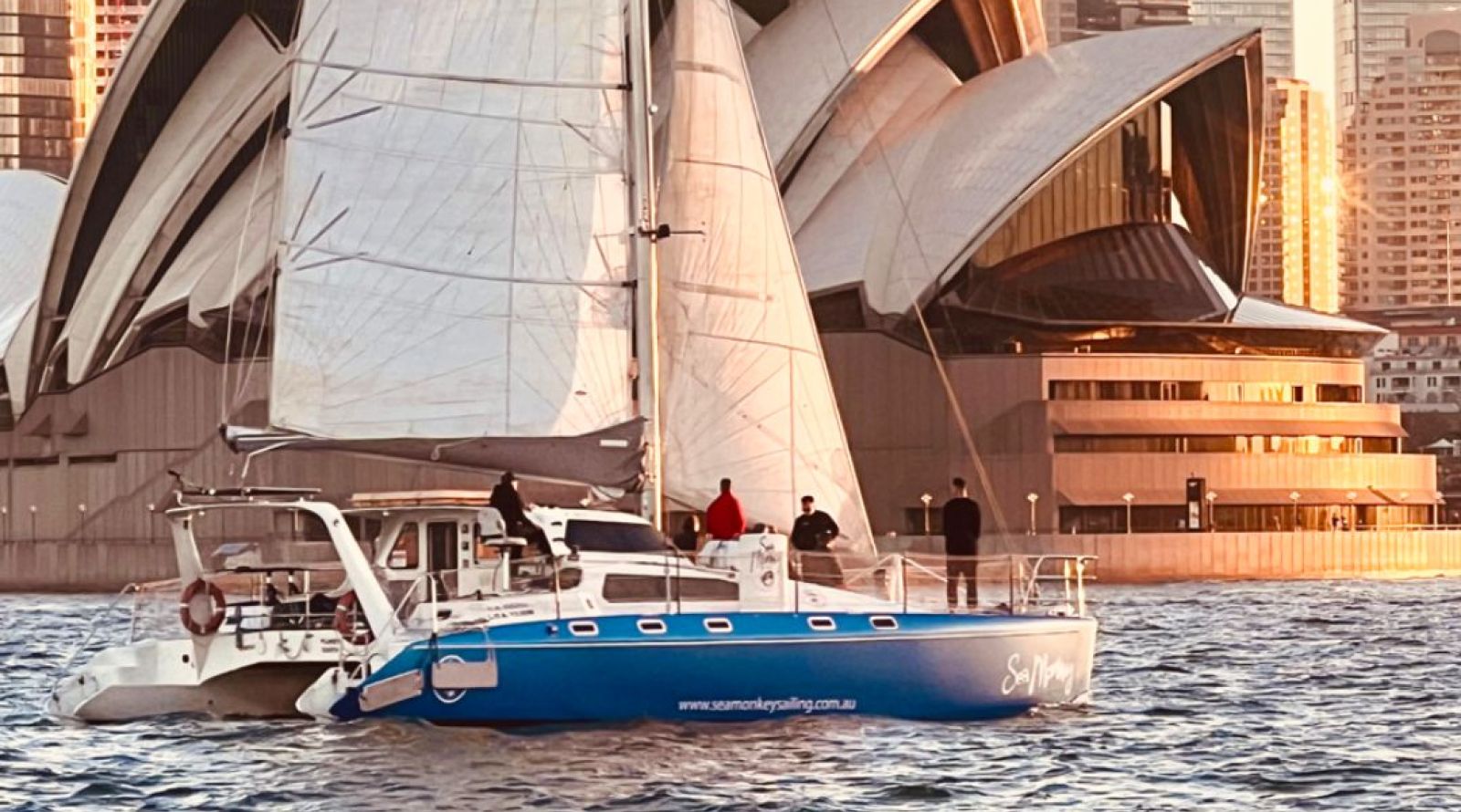 Sea Monkey Catamaran Sailing Past Opera House - private boat hire Sydney