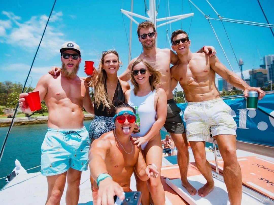 Boat party Sydney group on roof boat holding red cups